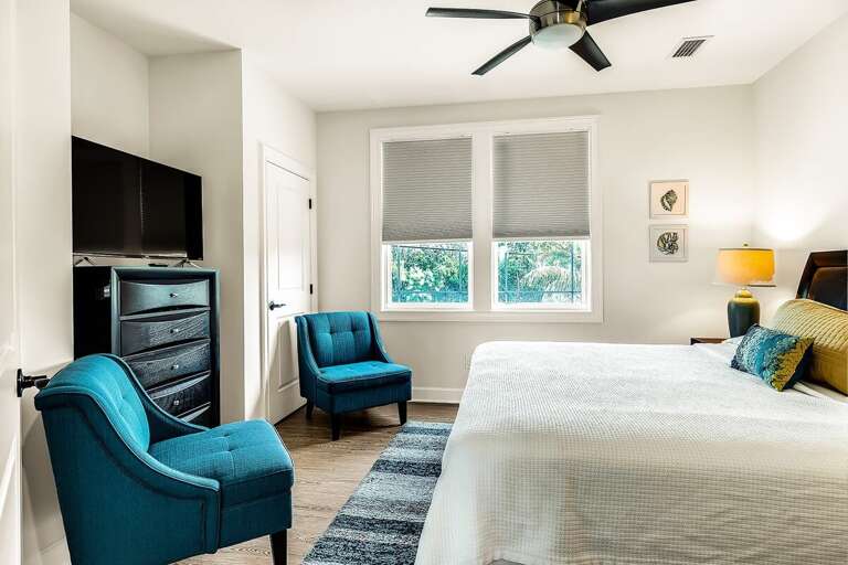 Relax in our spacious 2nd level king-size bedroom, complete with a TV and extra seating for added comfort.