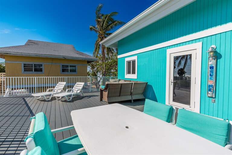 The sunny deck with plenty of seating and an outdoor table. The sunny deck with plenty of seating and an outdoor table.