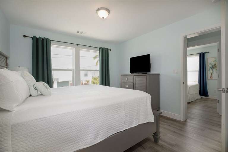 Your 2nd level master bed room complete with a spacious king-sized bed, ensuite bathroom, and the latest in entertainment with a TV setup.