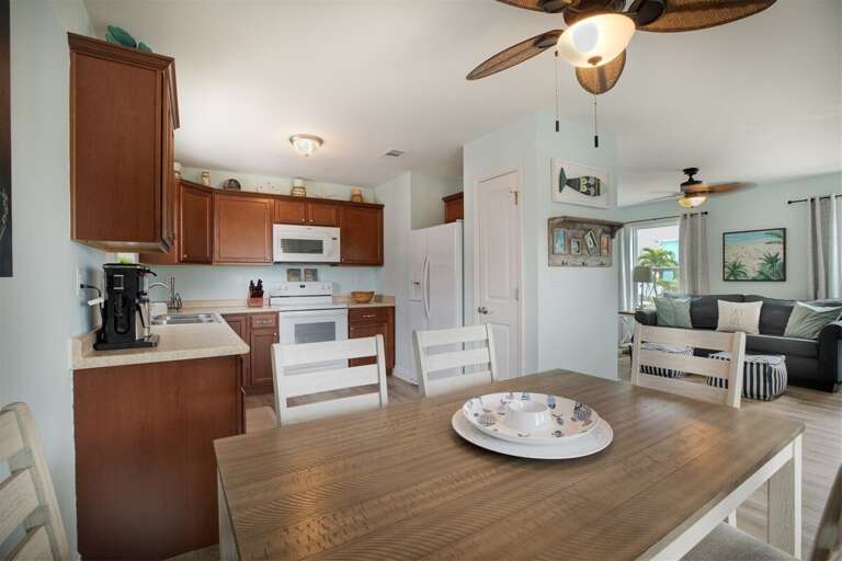 Experience the perfect blend of function and comfort: a versatile area seamlessly merging kitchen, dining, and living spaces, designed for effortless relaxation and entertaining.