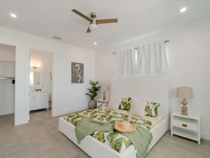 2nd level master suite 1 with a king bed and with water views.