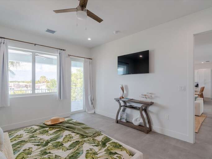 2nd level master suite 1 with a king bed and with water views.