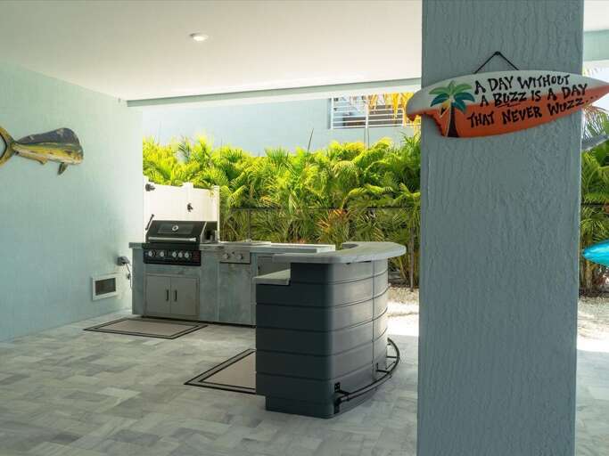 Outdoor kitchen with gas grill.