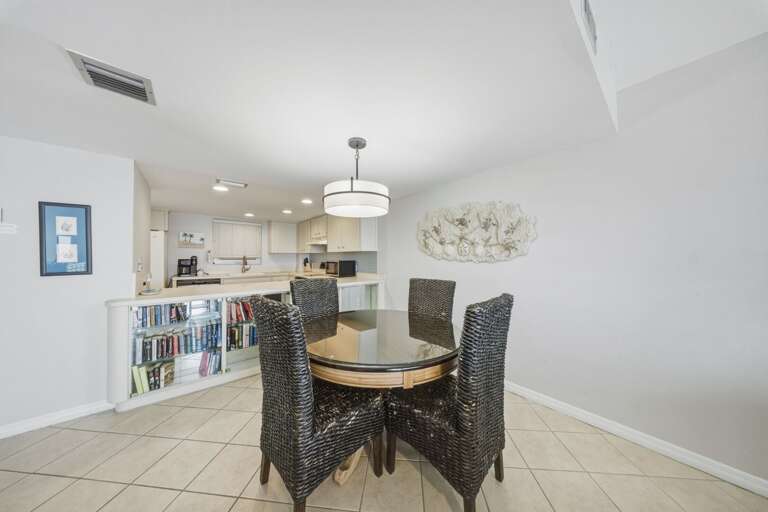 Conveniently located beside the kitchen, this dining area offers a comfortable space for shared meals and memorable gatherings.