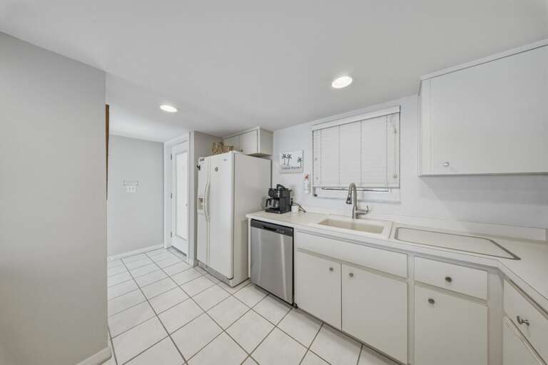 Featuring abundant cabinetry, ample counter space, and modern appliances, this kitchen offers everything needed for family meals and extended stays.