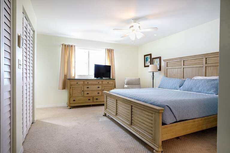 The master suite with a king bed and an en-suite full bathroom.