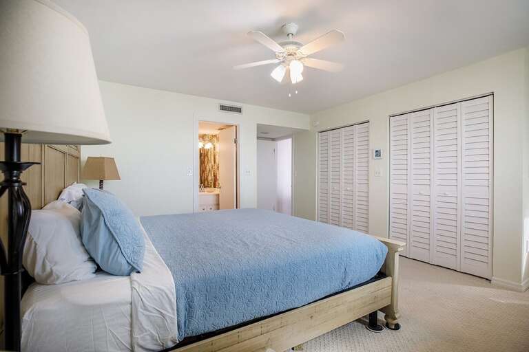 The master suite with a king bed and an en-suite full bathroom.