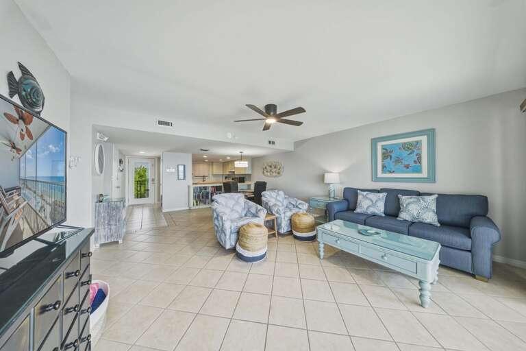 Plush seating, ocean-inspired colors, and natural light create a comfortable living space designed for relaxation and quality time together.