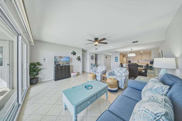 Sliding glass doors connect the living room to the balcony, bringing in ocean breezes and beautiful waterfront scenery.

Photo 10