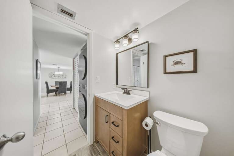Warm wood cabinetry, modern fixtures, and practical storage provide comfort and convenience for guests.