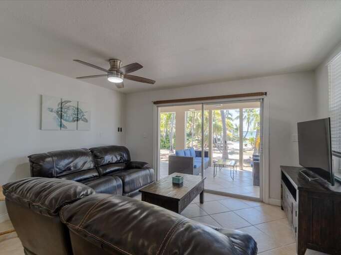 1st level living room with smart TV, Cable, and plush leather sofa