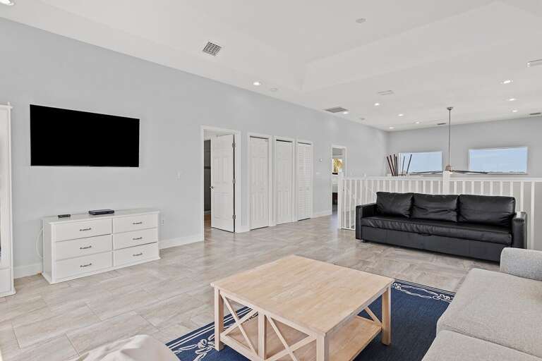 3rd floor living room with plenty of seating and a corduroy bean bag chair that opens up into a queen bed.