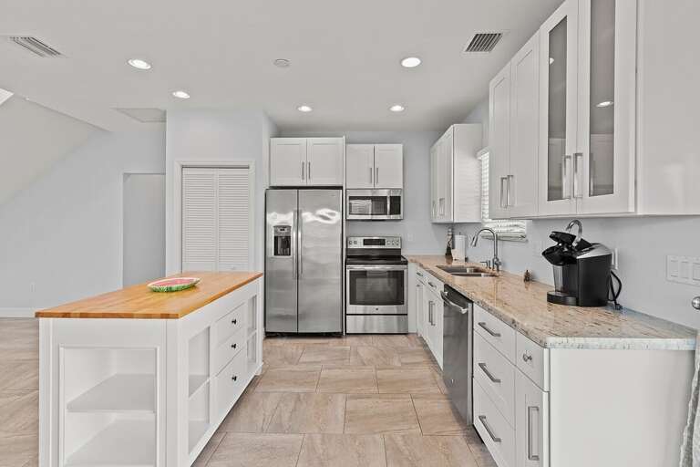 Kitchen stocked with all the essential cookware and appliances.