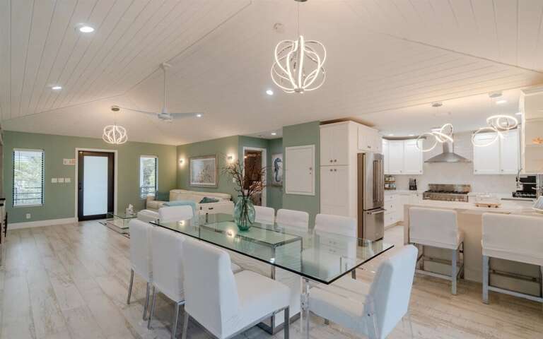 Feast in elegance: Where meals become memories around the sleek glass table, with room for everyone to gather. Feast in elegance: Where meals become memories around the sleek glass table, with room for everyone to gather.