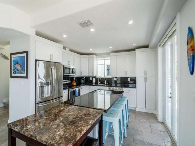Experience the joy of cooking in this fully-equipped kitchen, featuring a spacious center island and scenic canal vistas. Experience the joy of cooking in this fully-equipped kitchen, featuring a spacious center island and scenic canal vistas.
