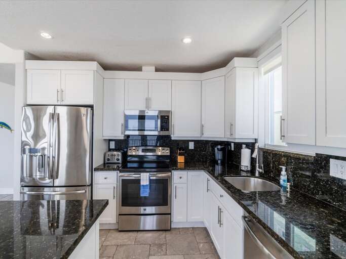 Experience the joy of cooking in this fully-equipped kitchen, featuring a spacious center island and scenic canal vistas. Experience the joy of cooking in this fully-equipped kitchen, featuring a spacious center island and scenic canal vistas.