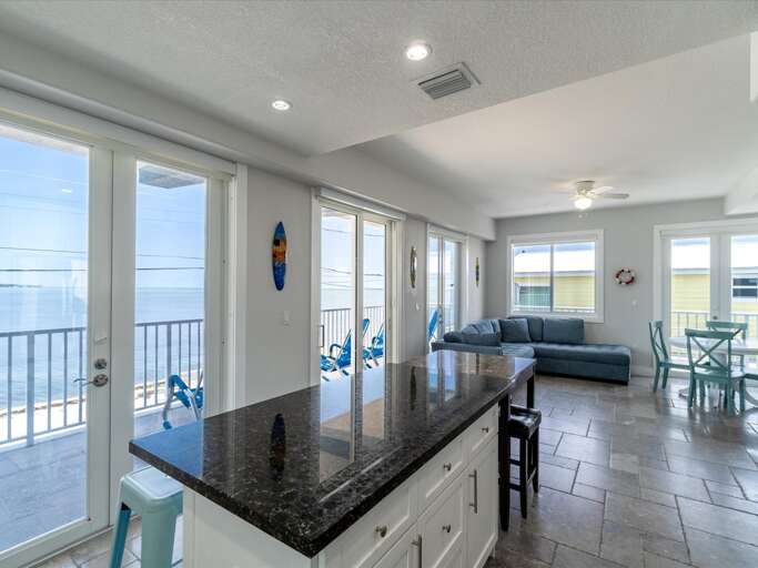 Unwind in this interconnected living room and kitchen, accompanied by captivating canal views and entertainment from the TV. Unwind in this interconnected living room and kitchen, accompanied by captivating canal views and entertainment from the TV.