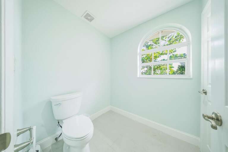 Designed for convenience and privacy, this separate water closet complements the spa-inspired primary bathroom.