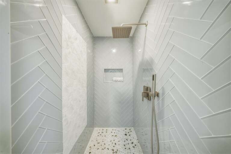 Designed with elegant finishes and modern amenities, this walk-in shower offers guests a relaxing experience after a day boating, fishing, or lounging by the heated pool.