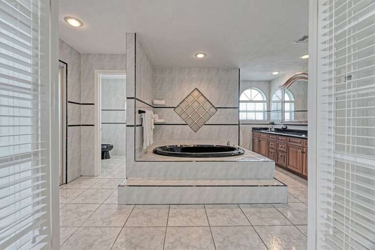 Relaxation awaits in our spacious ensuite bathroom, complete with a luxurious tub, adjacent to the Master Bedroom for ultimate comfort and convenience. Relaxation awaits in our spacious ensuite bathroom, complete with a luxurious tub, adjacent to the Master Bedroom for ultimate comfort and convenience.