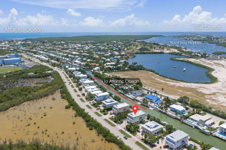 This aerial perspective showcases the home's convenient Sombrero Beach Road location near canals, boating, and the Atlantic Ocean.