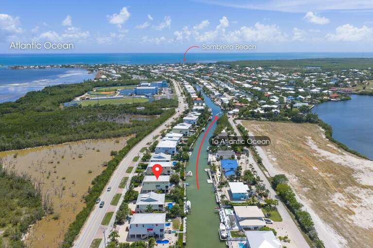 An aerial view highlights the rental's waterfront canal setting and desirable location in Marathon, Florida Keys.