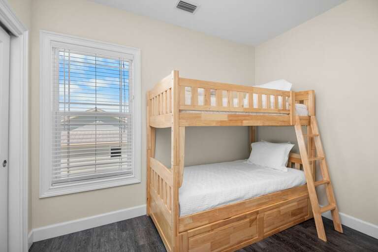 This cheerful bunk bedroom offers comfortable sleeping space for children or additional guests near Sombrero Beach.