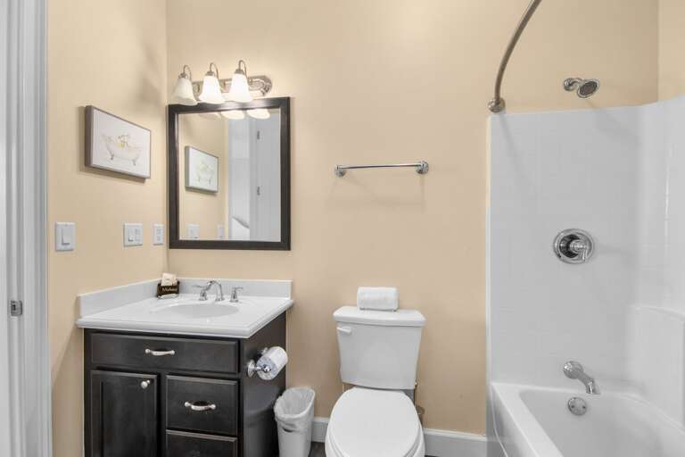 A clean, convenient guest bathroom includes a shower-and-tub combination, vanity, and fresh Florida Keys styling.