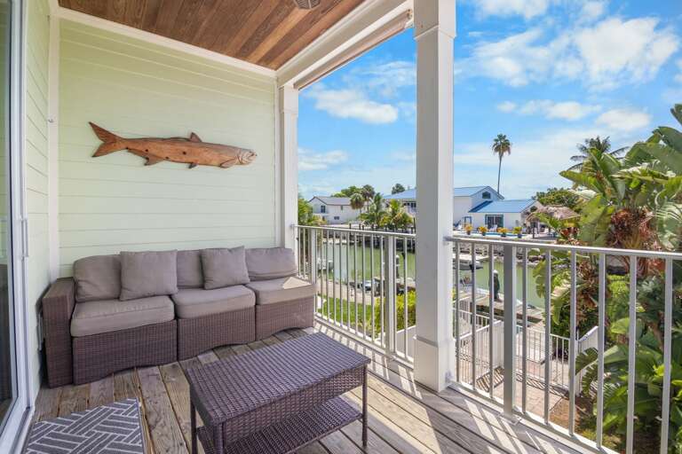 Enjoy morning coffee or evening breezes from a furnished covered balcony overlooking the tropical Marathon neighborhood.