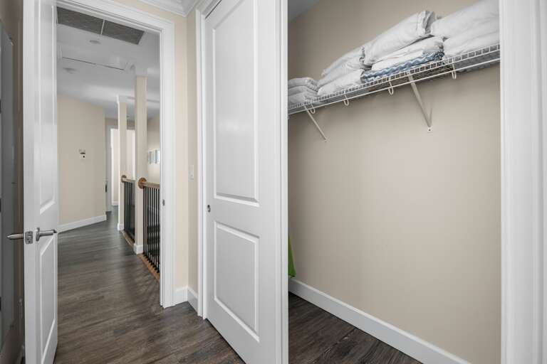 Organize clothing, luggage, and vacation essentials in a spacious walk-in closet with built-in shelving.