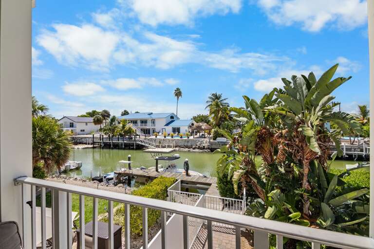 Take in peaceful canal and neighborhood views from the elevated balcony of this Sombrero Beach Road vacation rental.