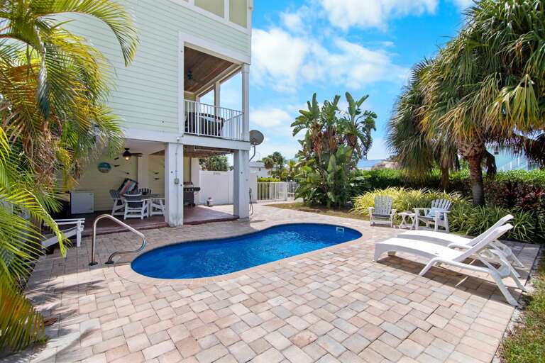 Relax beside the private pool on a spacious brick patio at this vacation rental near Sombrero Beach in Marathon.