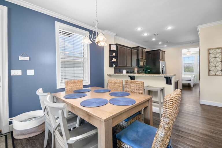 Share meals around a bright dining table conveniently positioned beside the kitchen in this Florida Keys vacation rental.
