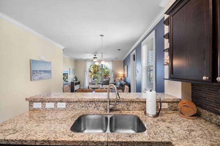 A spacious granite breakfast bar connects the kitchen and living areas, providing extra room for dining and entertaining.