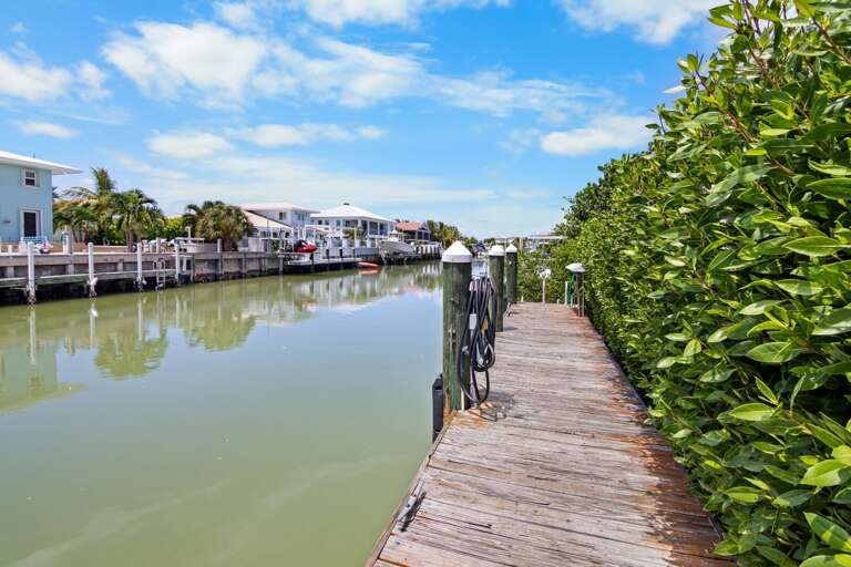 Walk along the private waterfront dock and enjoy convenient canal access from this Sombrero Beach Road vacation rental.