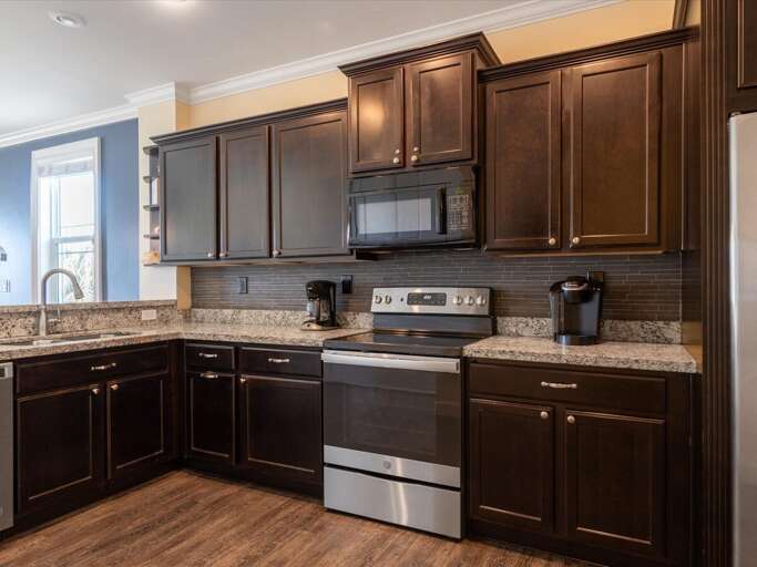 Cook in style with this sleek, modern kitchen featuring top-of-the-line stainless steel appliances. Cook in style with this sleek, modern kitchen featuring top-of-the-line stainless steel appliances.