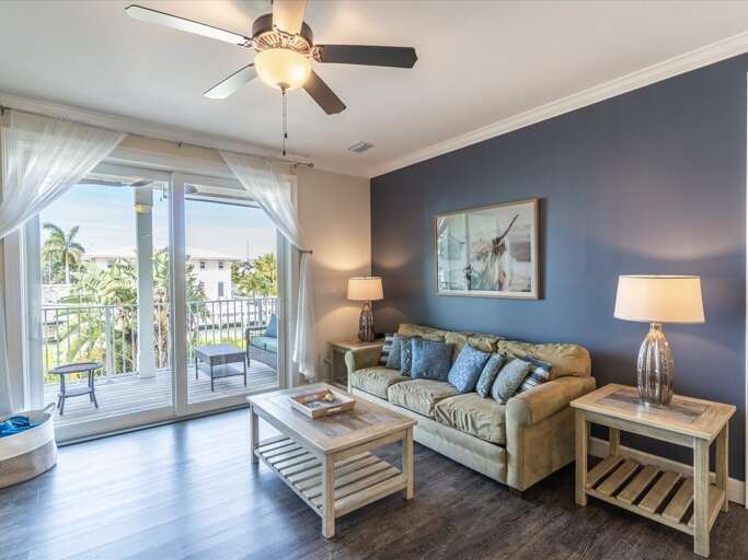 Relax in the cozy TV room with stunning canal views and a private porch. Relax in the cozy TV room with stunning canal views and a private porch.