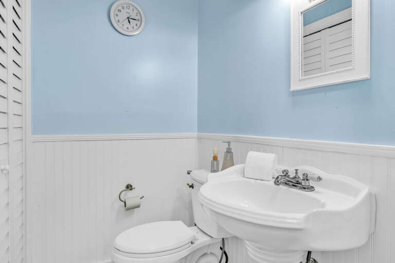 This well-appointed hall bathroom features stylish finishes and convenient access, perfect for guests staying in the common areas of this luxury Florida Keys home.