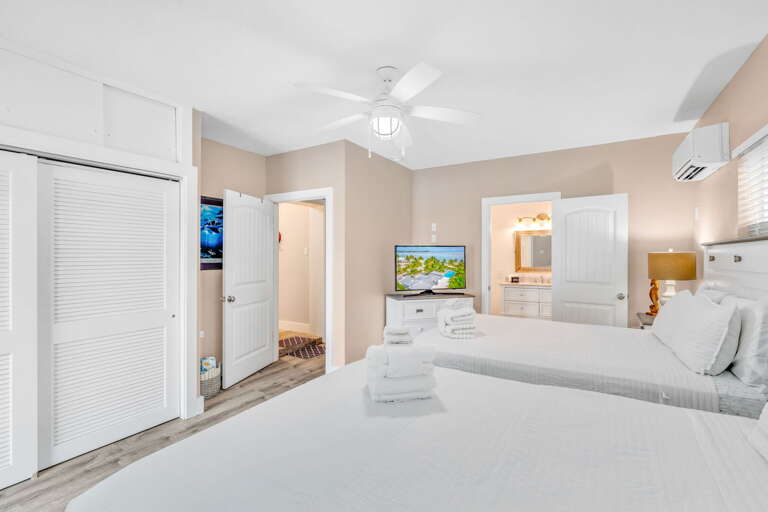 Bedroom 3 combines practicality and style with two full beds and smart entertainment, making it ideal for families visiting the Florida Keys.