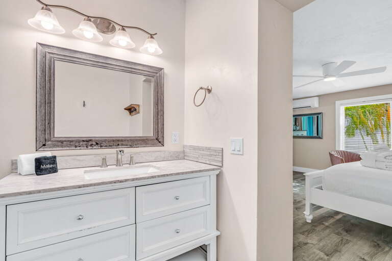 The master ensuite boasts a skylight that invites sunlight in, creating a warm and inviting spa-like ambiance in this upscale Marathon vacation home.