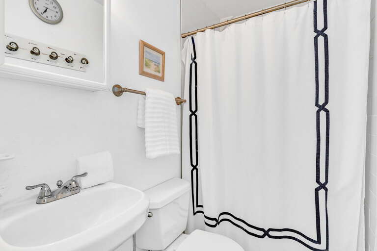 The modern ensuite bathroom attached to Bedroom 2 features clean design, premium fixtures, and all the amenities needed for a comfortable stay in this Florida Keys vacation home.