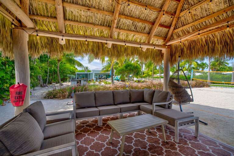 Nestled on the waterfront, this private tiki hut provides the perfect shaded escape. Surrounded by