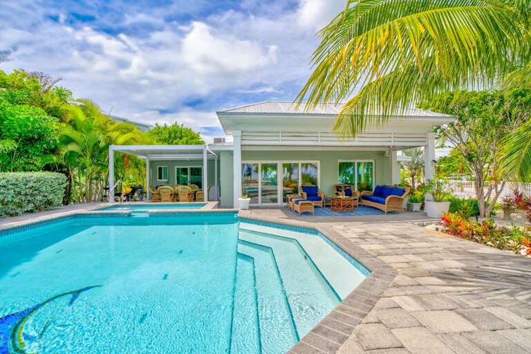 Perfect for families, this oceanfront pool features ample space for swimming, playing, and lounging. Enjoy sun-soaked days and sea breezes just steps from the Atlantic in your private vacation home.