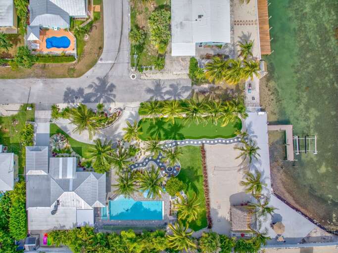 Set against a backdrop of the Atlantic, this tropical garden retreat features lush landscaping and tranquil green space, offering a serene setting to enjoy the natural beauty of the Florida Keys.