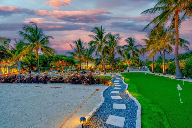 This spacious, pet-friendly private yard features lush tropical landscaping and secure fencing, providing a safe and beautiful space for your furry friends to play and explore in the Florida Keys.