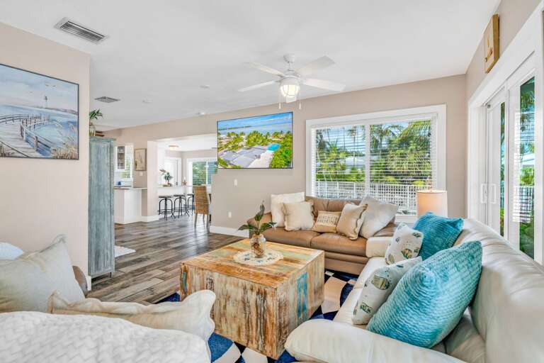 Sunlight floods this bright living room, where comfortable seating and ocean vistas create a serene environment to enjoy your Florida Keys vacation.