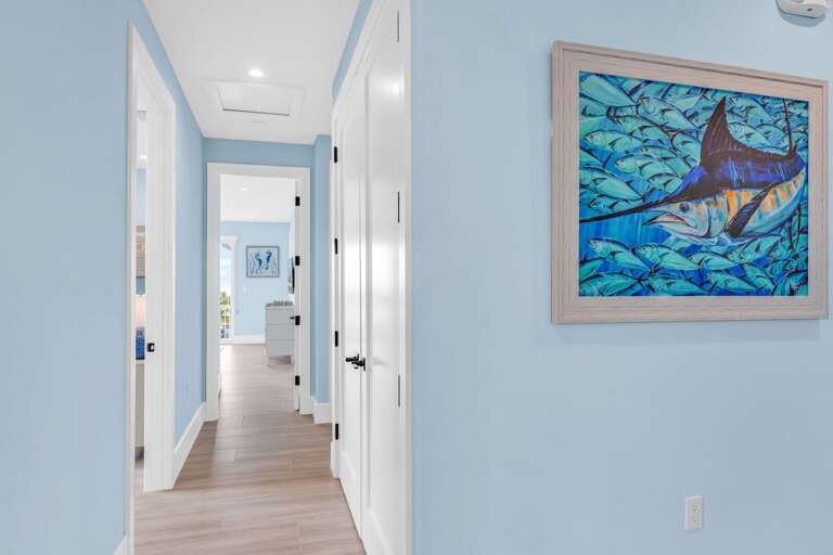 Bright and open third-floor hallway connecting bedrooms and bathrooms in this luxury waterfront home in Marathon, Florida Keys.