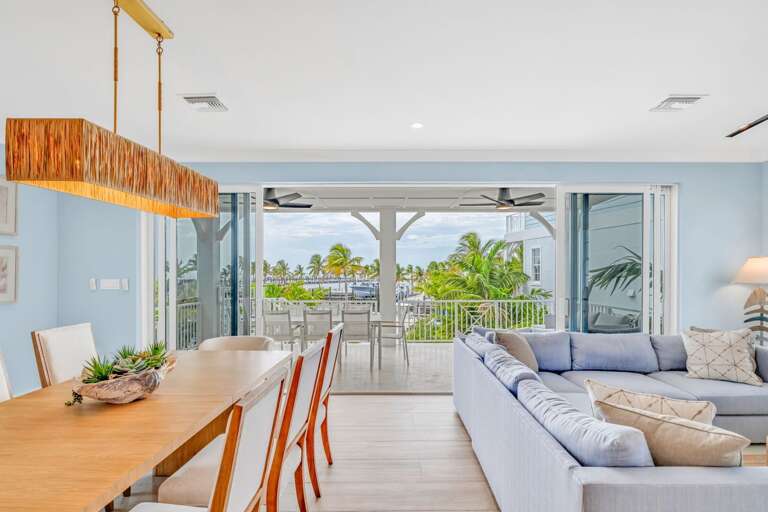 Coastal design meets comfort in this modern living room with panoramic Gulf views, perfect for lounging in luxury during your Florida Keys getaway.