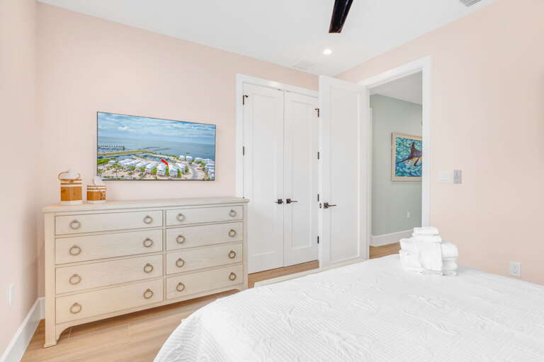 Comfortable third-floor queen bedroom featuring a smart TV, perfect for relaxing stays in this luxury Marathon Florida Keys waterfront rental.