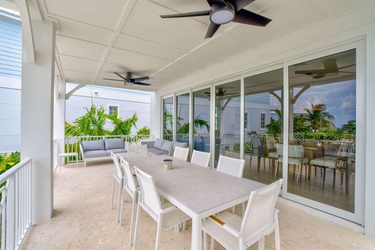 Enjoy meals al fresco with stunning Gulf views at this luxury outdoor dining setup, perfect for waterfront entertaining in your Florida Keys vacation rental.